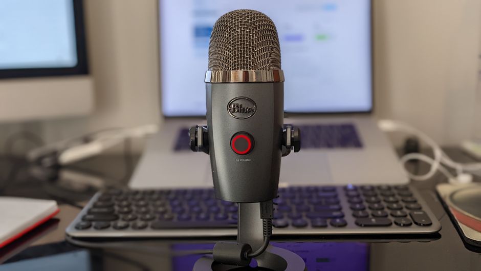 Dynamic podcast microphone on a boom arm at a desk