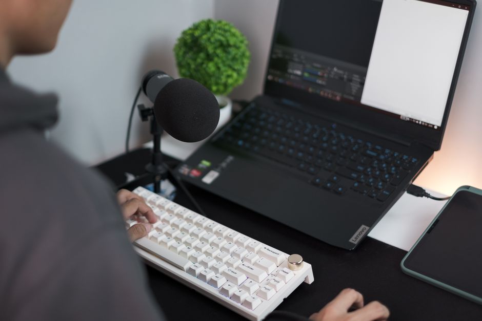 USB condenser microphone with pop filter at a home desk